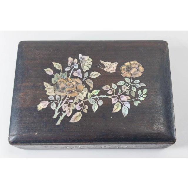 We are selling this very pretty Mother of Pearl or abalone inlaid wood box. The box is either Southern Chinese or...