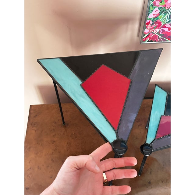 Two stained glasses triangular boxes on welded steel frames. Lids open at top and are connected with chain. Each is...