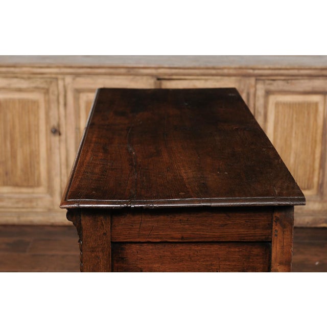 An English oak geometric front server from the late 19th century, with two drawers, carved apron, turned legs and side...