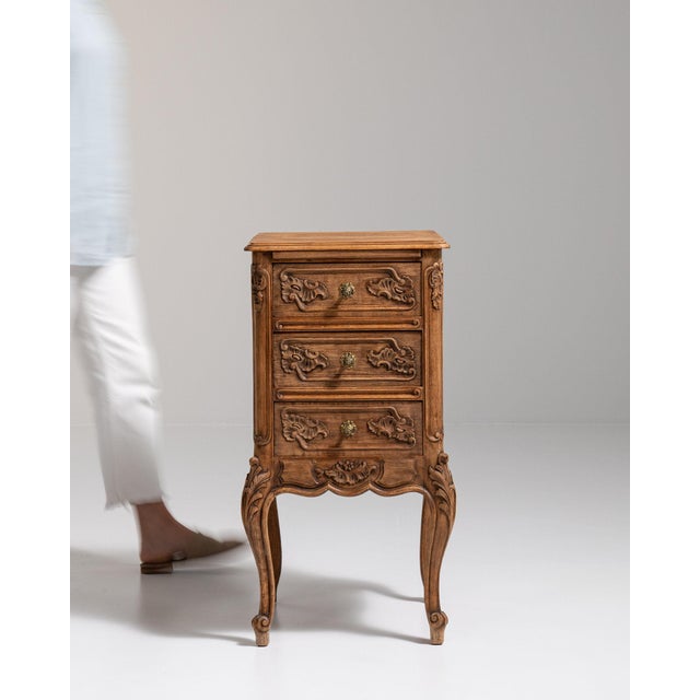 Carved oak petite commode in Golden Oak. The golden oak surface highlights two drawers, cabriole legs, floral carved...