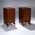 A pair of rectangular nightstands with a slightly convex door and conical brass legs. The nightstands have an interior...