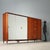 Large Italian-made wardrobe from the 1950s featuring elegant exotic wood veneer, providing a warm and sophisticated...