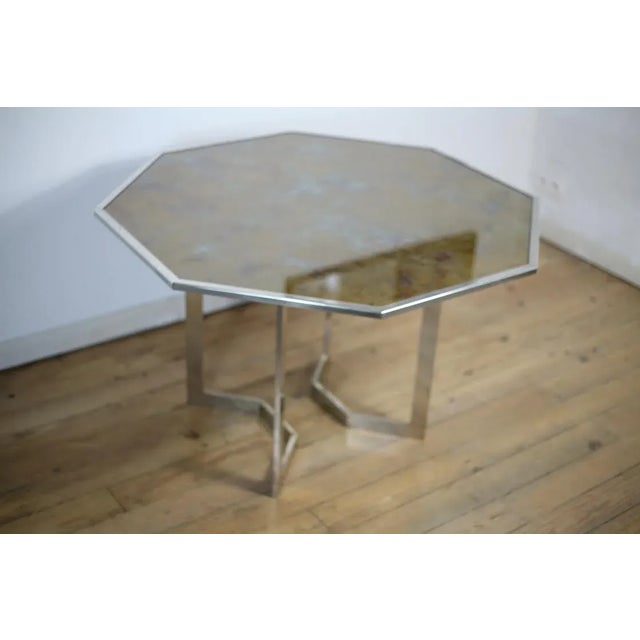 Chromed steel table and glass top 70's, France. Octagonal wooden top with a ''fake tortoise shell'' motif and a glass top...