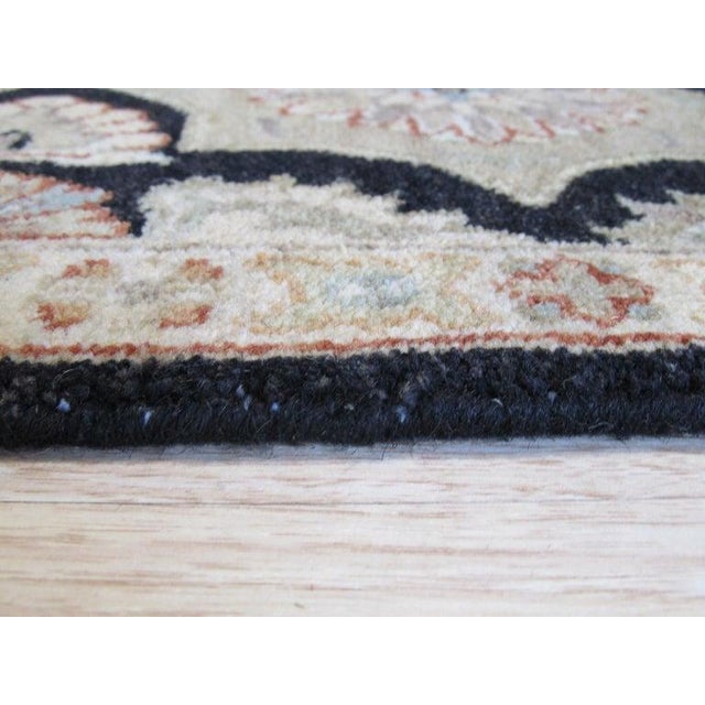 This hand knotted pile rug features a primary color palette of ivory, beige, cream, and white. Crafted from natural wool,...