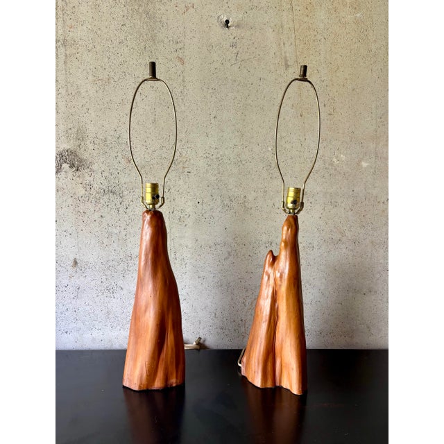 A striking pair of Mid-Century Modern table lamps handcrafted from solid cypress root, each showcasing the natural grain,...