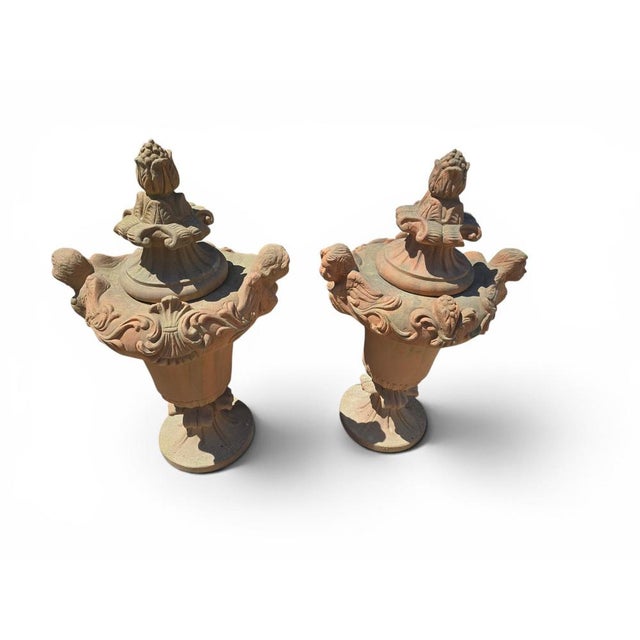 Elegant pair of Italian terracotta urns dating from the 1970s. Crafted in the traditional Mediterranean manner, these...