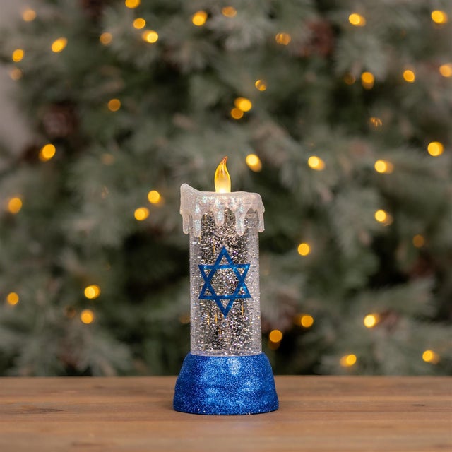 Celebrate the season with a sparkling twist on tradition. This Hanukkah candle snow globe features a classic pillar candle...