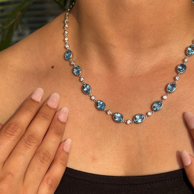 This Handcrafted Blue Topaz and Zircon Stone Station Necklace exquisite station necklace, crafted in fine 925 sterling...