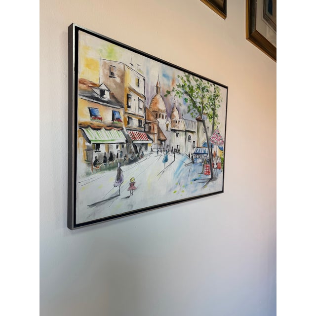 A charming 1980’s oil on canvas painting depicting a lively Parisian cityscape street scene, signed “Beverly” in the lower...