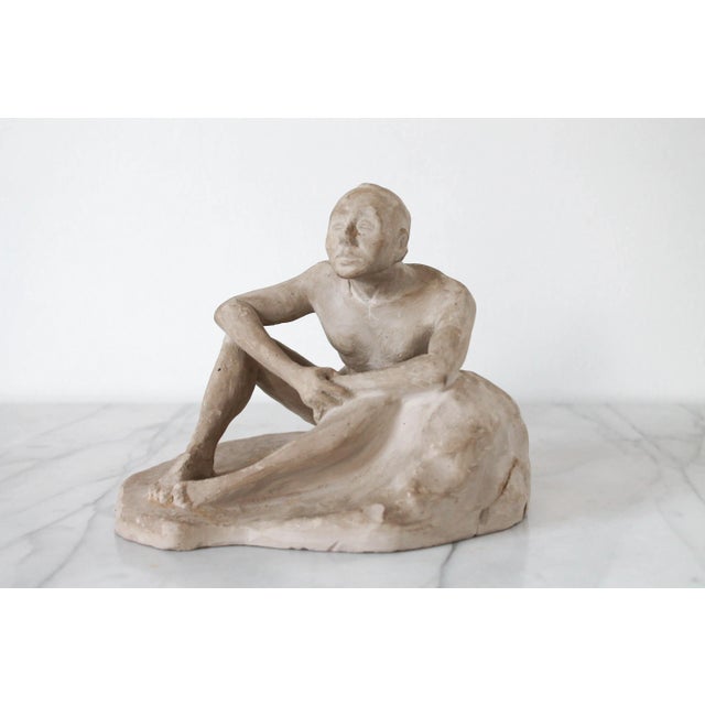 1950's seat nude figural male clay sculpture. No makers mark. One older repair, small nicks. Pictured.