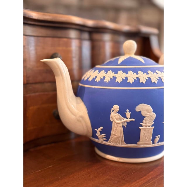 A striking antique Copeland Late Spode teapot crafted in cobalt-blue jasperware with finely applied cream-colored...