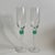 Refined pair of vintage champagne flutes that feature delicate clear glass bowls and green rings at the stem. With clean...