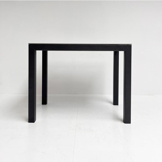 In mint condition, this not-too-large dining table by Bert Plantagie. The table stands on a grey metal frame. A grey stone...