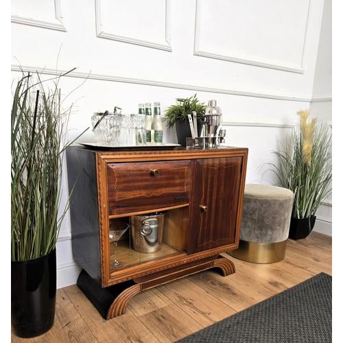 Very elegant Italian side table in typical Art Deco shape and materials with its beautiful wood, two openings and the...