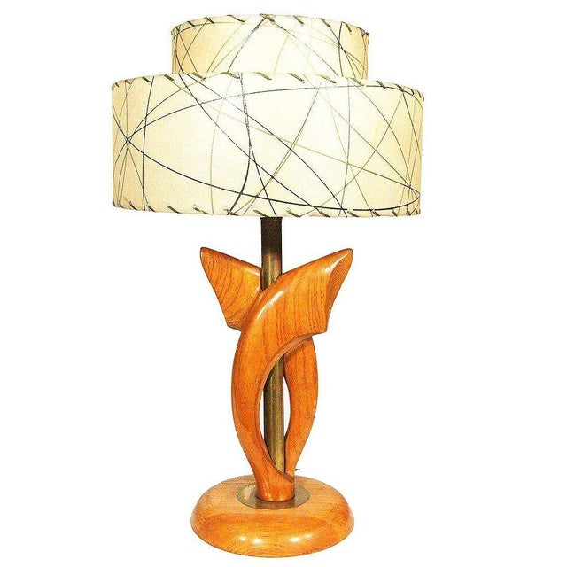 This pair of Yasha Heifetz-designed table lamps features sculptural oak forms enveloping their cylindrical brass supports....