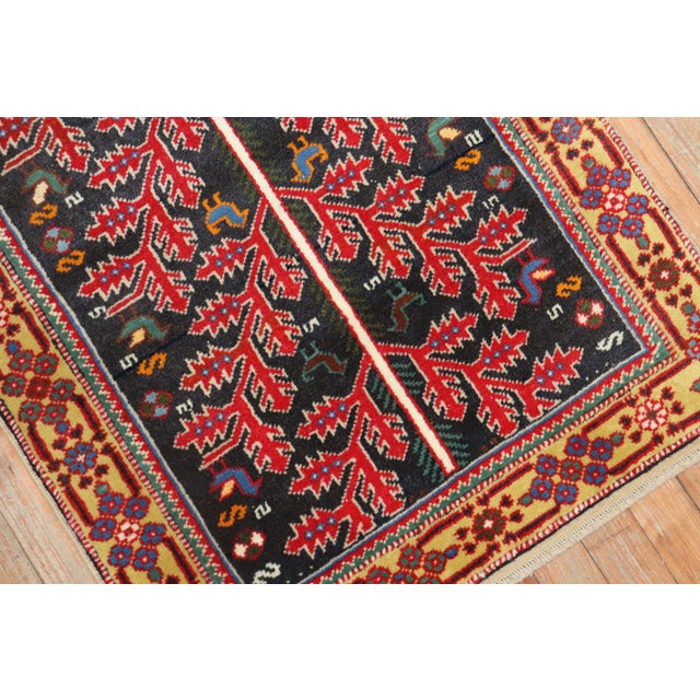 Mid-20th century Persian rug with a colorful Primitive all-over design on a dark background Measures: 2'3" x 3'2".