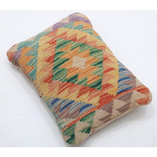 A one-of-a-kind handwoven Afghan wool kilim lumbar pillow featuring harlequin diamond field. Cut and sewn by hand from a...