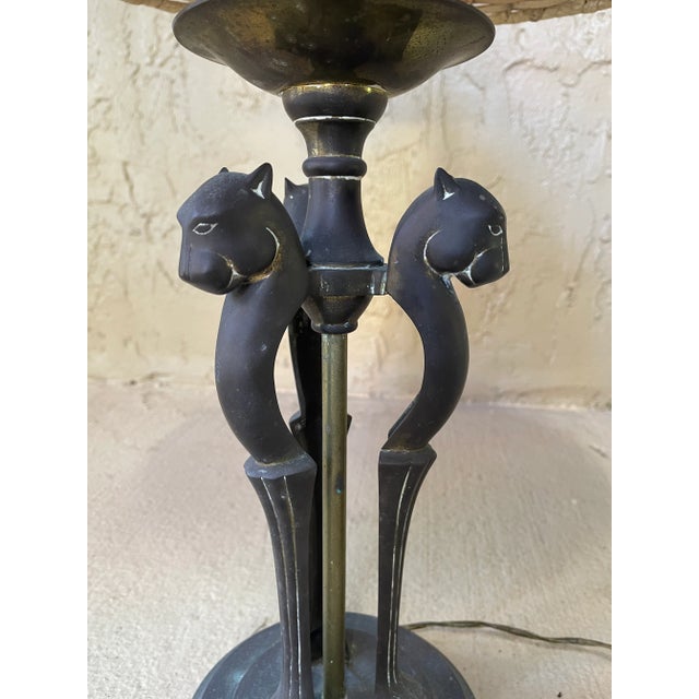 Stunning brass Sarreid table lamp featuring three panthers. Wear consistent with age with wonderful patina. Lampshade is...