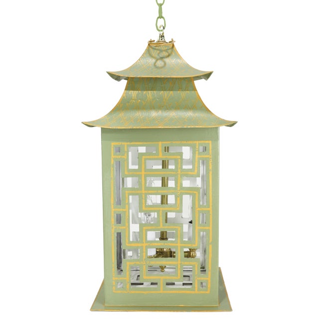 Vintage pagoda form chandelier crafted in painted tole, finished in soft green with hand-detailed gilt accents. The tiered...