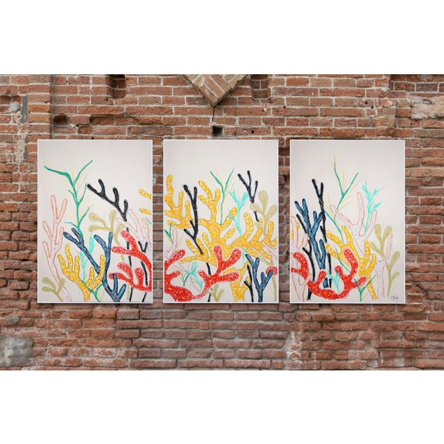 This vibrant triptych evokes an abstract coral garden, where branching forms and primary tones echo the delicate...