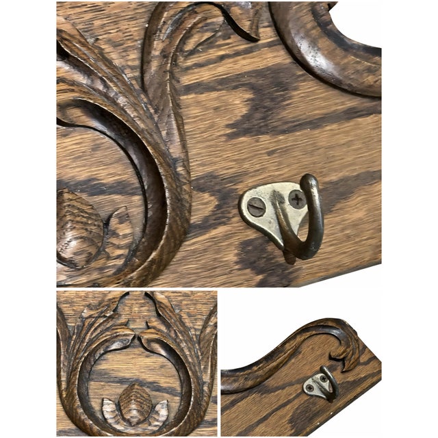 A beautifully carved vintage wooden wall-mounted rack featuring 4 metal hooks. Highlighted by intricate ornate floral...