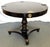 Timeless vintage pedestal table from the late 20th century. The neoclassical style table is made of heavy wood in a deep...