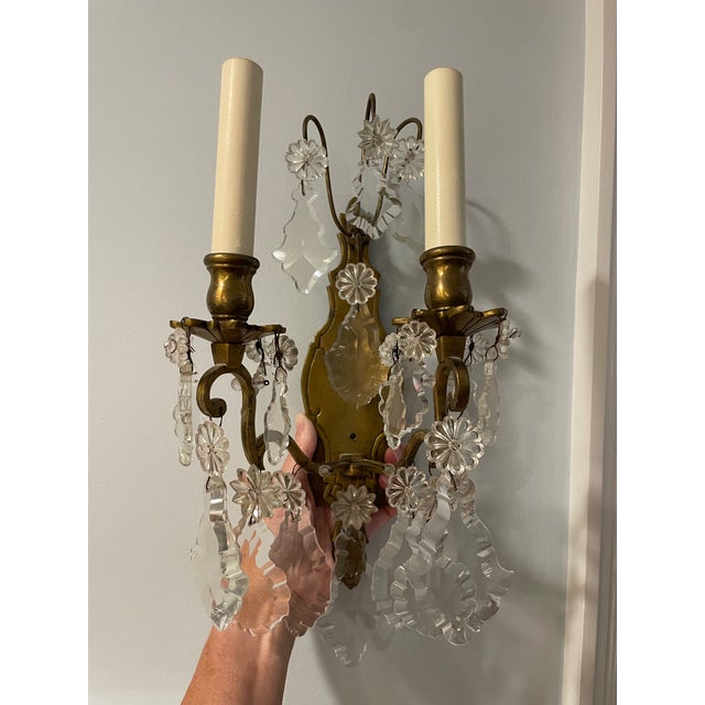 This is a pair of beautiful sconces are elegant and feature two gracefully curved arms crafted from a warm brass. The...