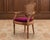 An elegant walnut and cane fauteuil armchair crafted in the grand French Louis XVI style. The distinctive chair features a...