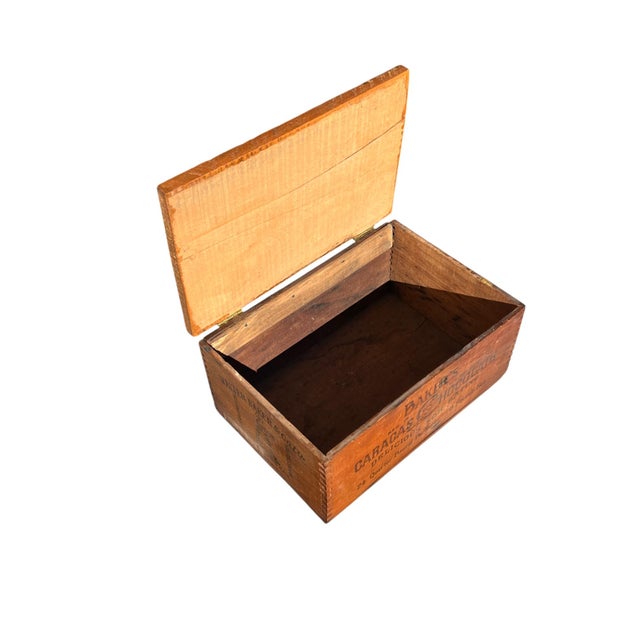 This lot includes 2 wood cocoa boxes from the early 20th century and Cocoa and Chocolate Exhibition booklet from the...