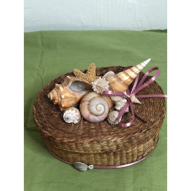 Little vintage woven wicker box with detachable lid. The lid has been decorated with a collection of shells and a...