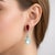 Dangle earrings crafted in 18k gold, featuring pear-cut aquamarine stones totaling 7.08 carats in a striking blue hue....