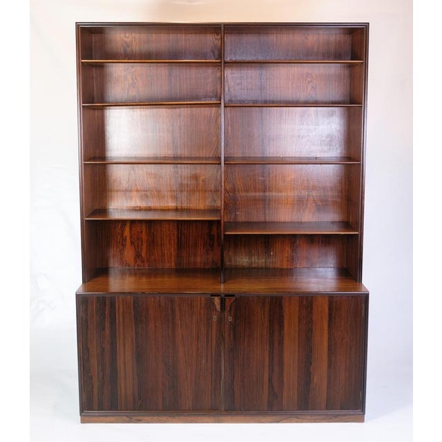 Tall bookcase in rosewood, designed by Frode Holm and sold through Illums Bolighus in the 1960s. Made with adjustable...
