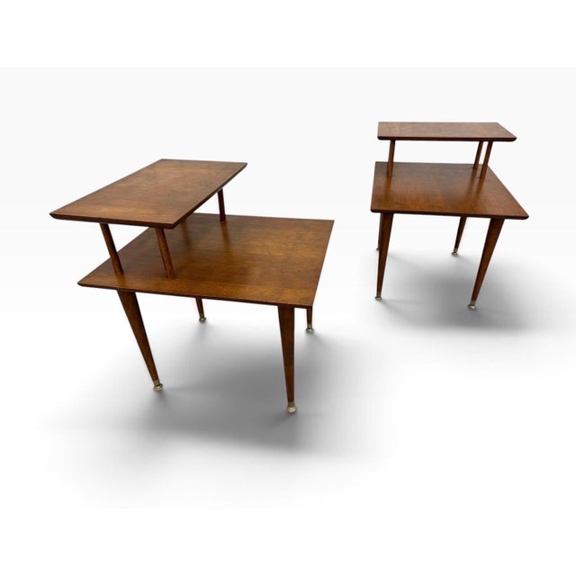 Add authentic 1960s style to your space with this handsome pair of Mid-Century Modern walnut step side tables. Featuring...