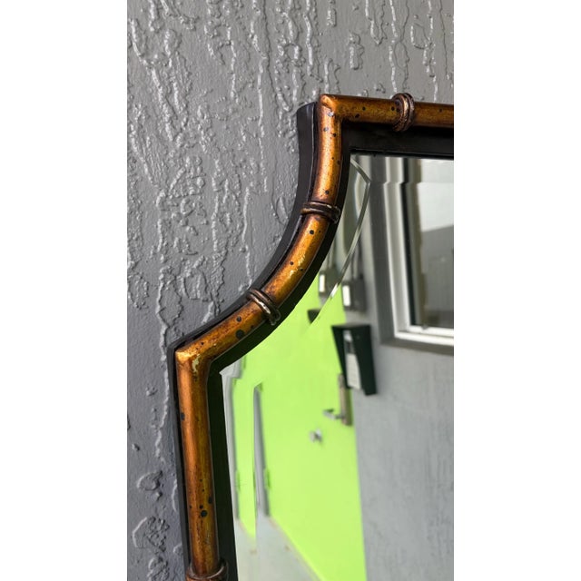 This is a modern stylized pagoda mirror. It is solid wood with gold gilt metal faux bamboo overlay. The mirror itself has...