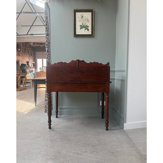 This 19th-century stepped writing desk is captivating with its scalloped gallery, twisted columns, and the depth of its...