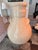 Large decorative ceramic vase featuring a warm ivory crackle glaze with an elegant rounded silhouette and sculptural...