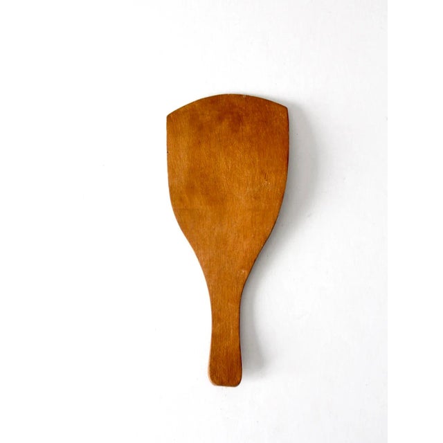 This is an antique butter spatula. The primitive wooden kitchen utensil features a hand-painted floral design in green and...