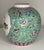 Chinoiserie vase features flowers and birds on brightly colored vessel. Flowers in various shades of blue and pink on a...