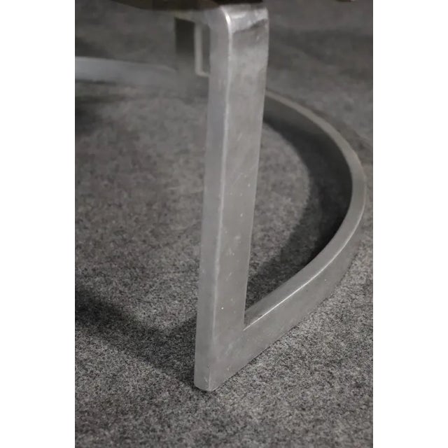 Round mid-century modern club chairs set on strong metal bases. Soft velvet like fabric accents the heavy metal base.