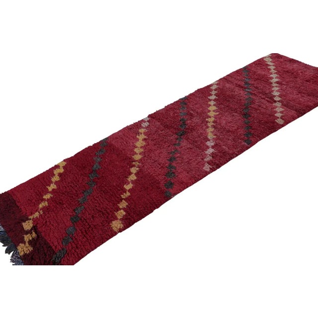 Hand-knotted in wool circa 1950-1960, this vintage 3x9 Moroccan runner is believed to hail from the Azilal tribe. On the...