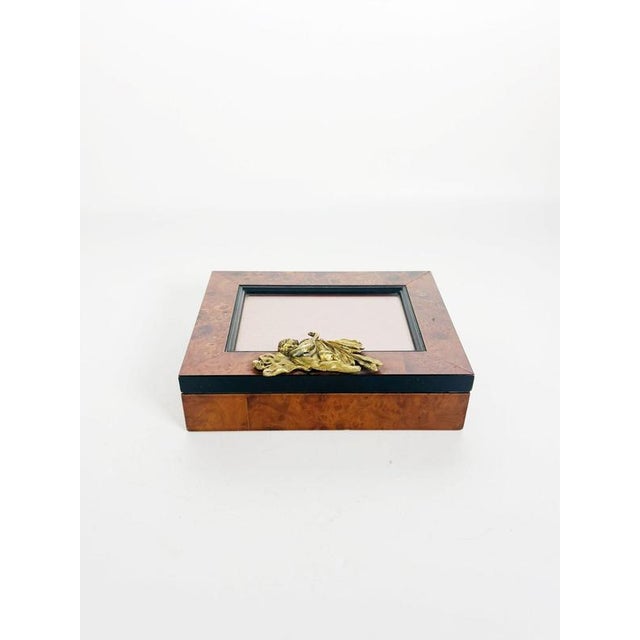 Elegant French decorative box from the 20th century, crafted from richly figured burl wood, glass, and brass, combining...