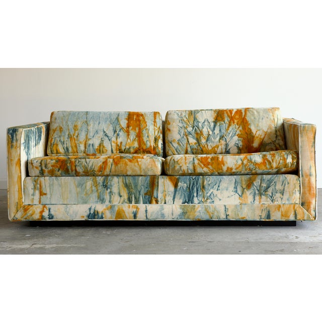 A striking mid-century modern tuxedo-style sofa manufactured by Founders Furniture, upholstered in an extraordinary hand-...
