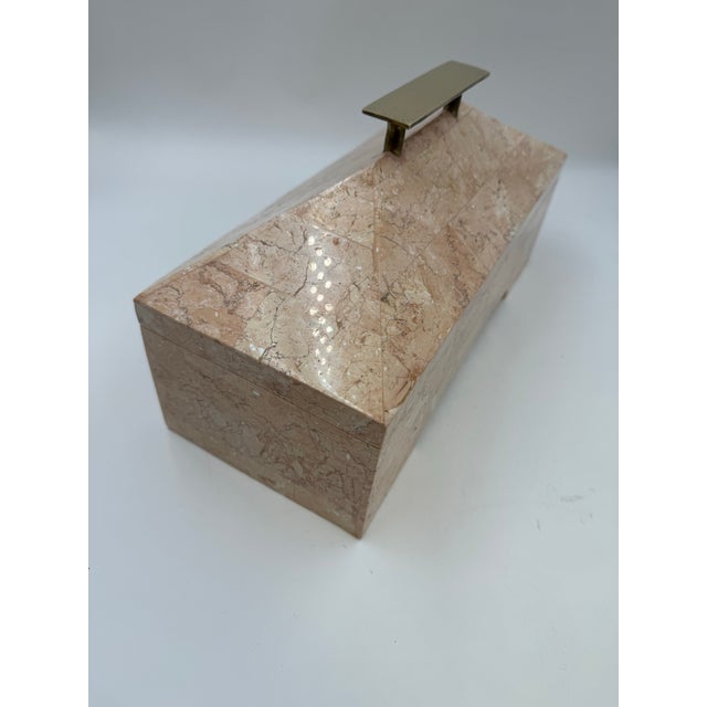 A beautifully crafted vintage tessellated stone jewelry box in soft blush pink marble with a sculptural brass handle, in...