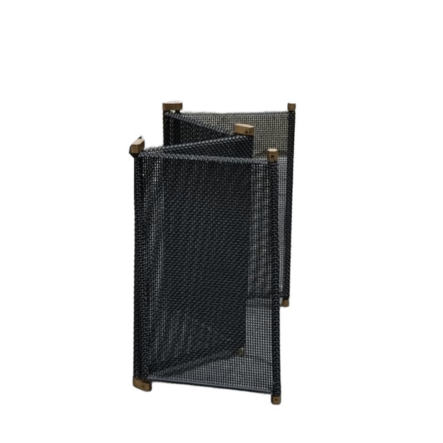 Rare and beautiful iron fireplace screen with brass details, engraved with the Dimensione Fuoco brand name. The screen...