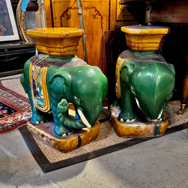 This is a classic pair of Sancai stoneware garden seats in the form of green glazed elephants with raised and curled...