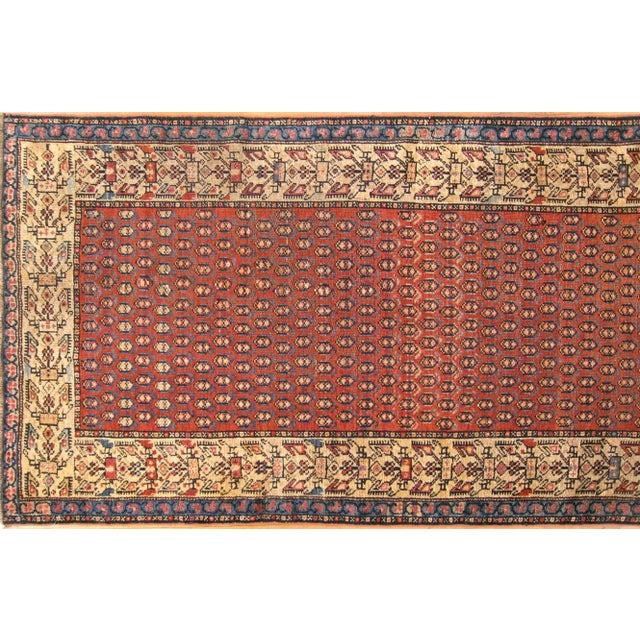 An antique Persian Malayer oriental rug, circa 1910, This handsome hand-knotted carpet features a repeating "boteh"...