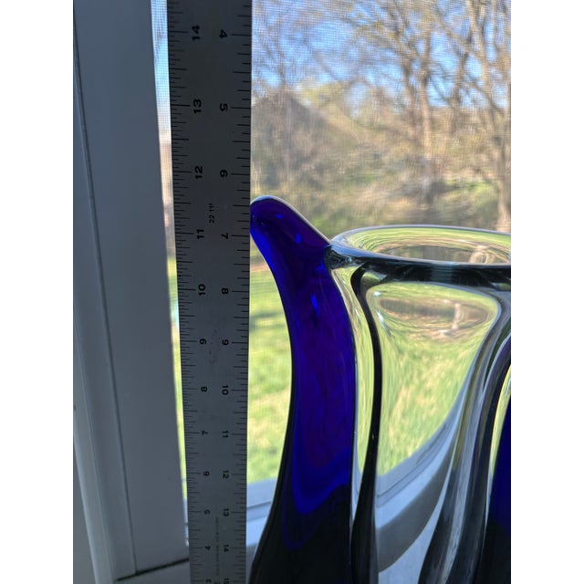 Jaroslav Svoboda Karlov art glass vase featuring a clear inner body and bold blue sculptural wings. Signed on bottom.