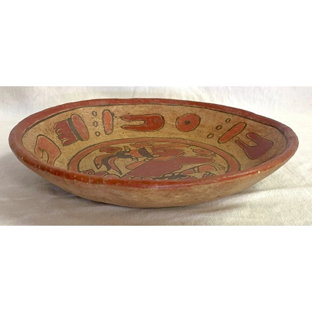 Unique folk art pottery dish from the mid 20th century. It's made of ceramic clay, perhaps terra cotta, and has tribal...