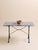 A beautifully balanced table featuring a substantial marble top resting on an elegant iron base. The stone showcases...
