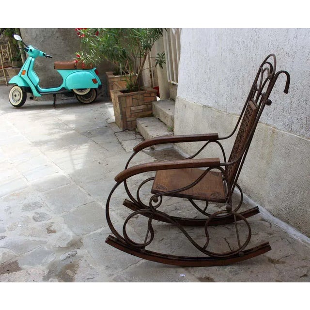 Metal base and the fruit wood rocking chair early 20th century. Rocking chair is from the Bassano Del Grappa in Veneto...